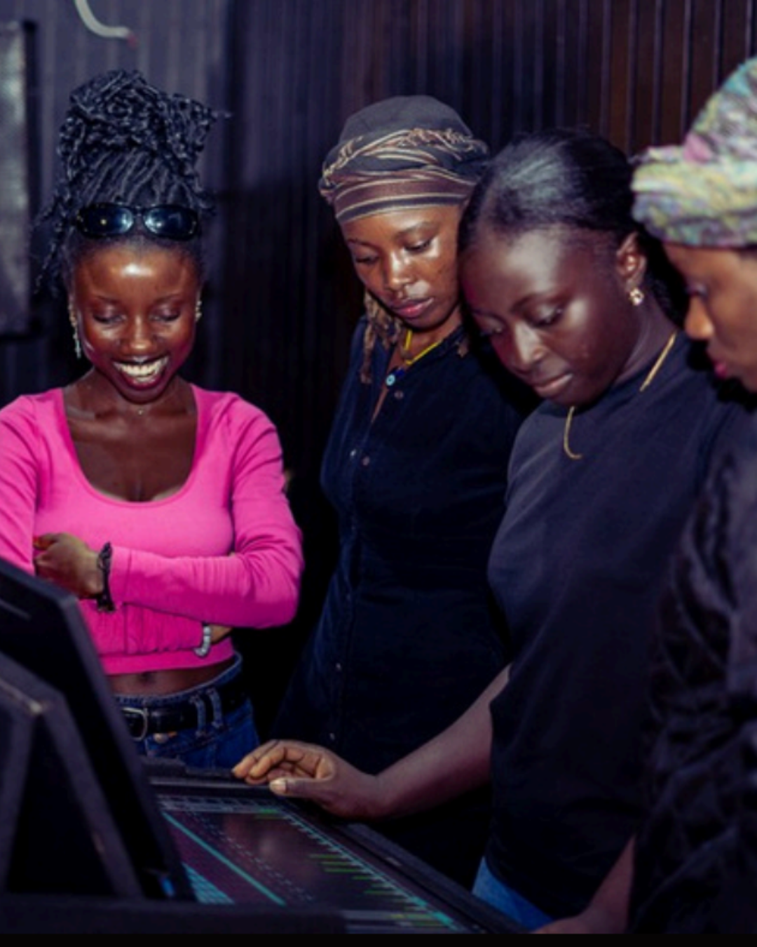 Young women training at a mixing console